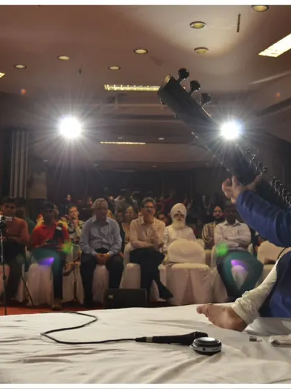 A dramatic shot from the stage at the India Habitat Centre, capturing the energy of a live concert.