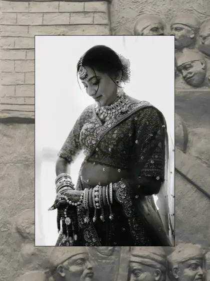 A timeless black and white portrait of a bride looking down, her intricate jewelry and delicate features highlighted beautifully.