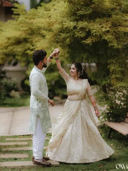 A couple shares a dance in a beautiful garden, a perfect candid moment from their pre-wedding celebration.