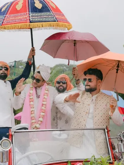 The baraat arrives in style, even in the rain. For Ayesha and Abhishek's wedding, the groom made his entrance in a vintage car, and the celebration continued with umbrellas and unstoppable dancing.