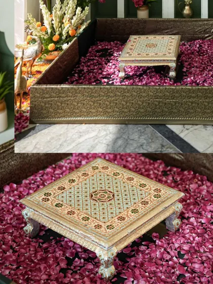 Our contemporary take on urli-style seating, with custom-painted chowkis placed in boxes filled with flower petals, blending North and South Indian traditions.