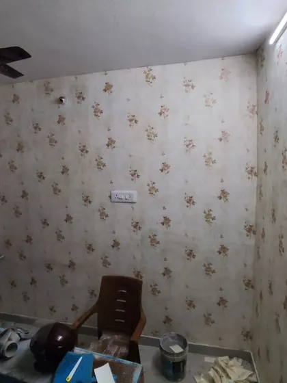 A room with a delicate, small-scale floral wallpaper. The subtle pattern adds a touch of vintage charm and is perfect for creating a cozy atmosphere.