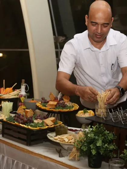 Here I am, arranging breadsticks on a beautiful buffet. We take pride in managing every aspect of the food display to create a seamless experience.
