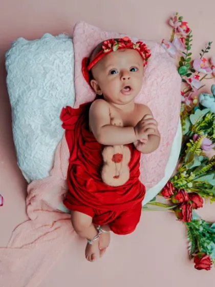 A curious little blossom. This three-month-old baby is awake and alert, taking in the beautiful floral world I created for them.