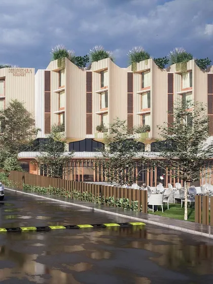 The entrance view of the Bellevue Club shows how guests arrive. The design provides a clear sense of entry while maintaining a connection to the outdoor landscape through transparent ground-floor walls.