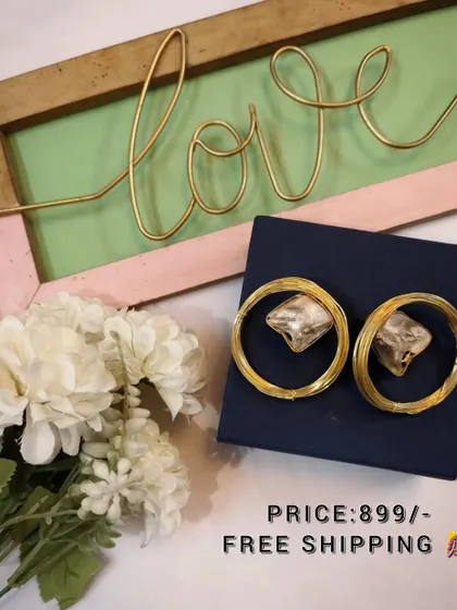 A beautiful flat-lay of the large brass and crystal hoop earrings, perfect for gifting.