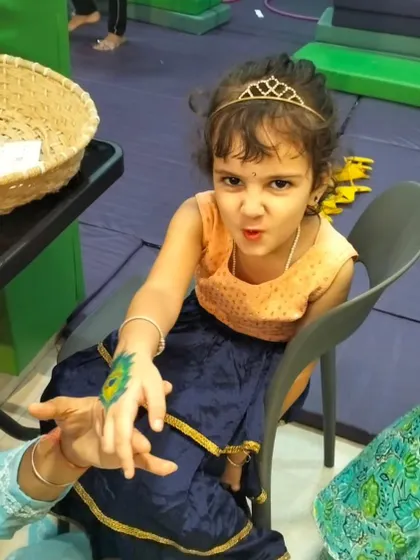 Even our little Radhas get in on the fun with beautiful peacock feather tattoos. It's all about celebrating our culture with joy and creativity.