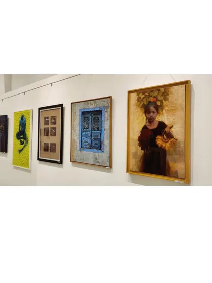 A view of the gallery wall at the Maharashtra State Art Exhibition, showing my painting among other works.
