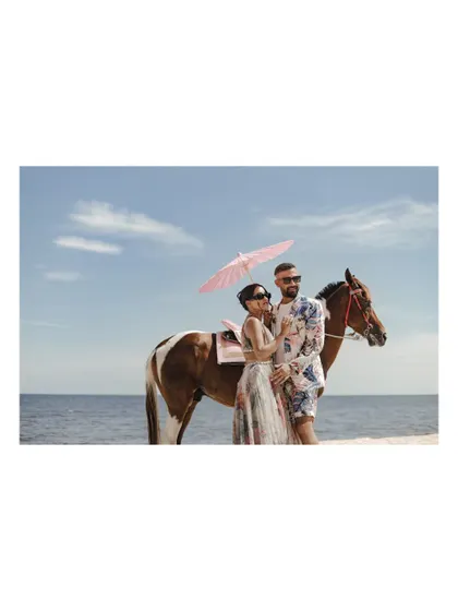 A black and white version of the stylish beach photoshoot with a horse.