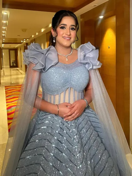 The full view of this pastel paradise look, showcasing the stunning gown and the glamorous makeup that completes the ensemble.