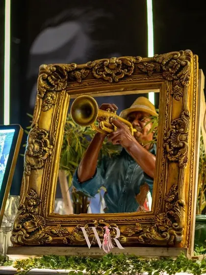Another detail from the bar, with a miniature trumpeter figurine framed in an ornate gold frame, showcasing our commitment to carrying a theme through to the smallest details.