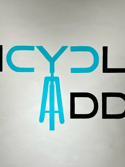 The hand-painted logo for Bicycle Adda, where the 'A' is cleverly designed to look like a bicycle frame. This small detail adds a custom touch to the store's branding.