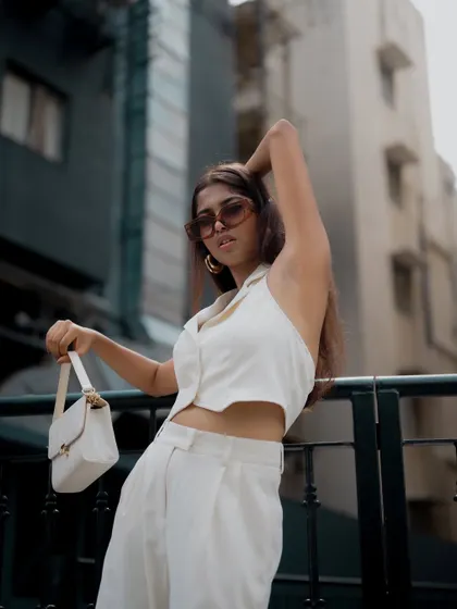 A duplicate of image 238, this profile shot of a model in a chic white outfit is minimalist and stylish.