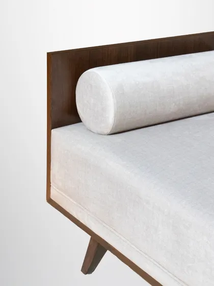 A detail of our wooden wonder sofa, showing the integrated bolster pillow and the clean lines of the wood frame.