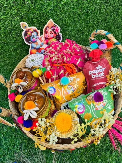 A top-down view of our Holi hamper, showing the arrangement of goodies like Paper Boat drinks, organic gulal, and decorated jars.