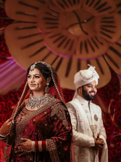 A beautiful portrait of the bride, with the groom slightly out of focus in the background, creating a sense of anticipation and story.