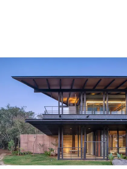 The completed Lakeshore house, a composition of precise metalwork and earthy, rammed walls. The project is a duet between the site and the architecture, a home that is both modern and deeply rooted in its place.