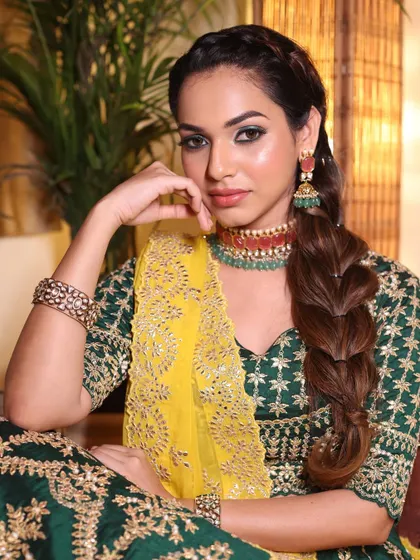 A powerful and confident pose, showing off the full Mehendi look.