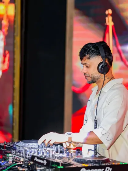 In the zone, mixing tracks at a high-profile event. My focus is always on the music and the technical details that create a perfect audio experience.
