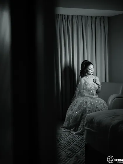 A dramatic black and white portrait of the bride-to-be, using shadows and light to create a moody and artistic feel.