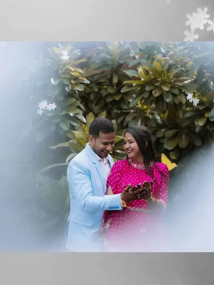 Elegant portraits of a couple in a lush garden setting, likely at a palace hotel like Samode. The vibrant pink and blue outfits create a beautiful contrast with the greenery.