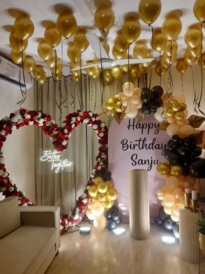We combined a lush floral heart arch with a modern balloon garland for this grand birthday celebration. The 'Better Together' neon sign adds a personal touch, making it a great backdrop for both birthdays and anniversaries.