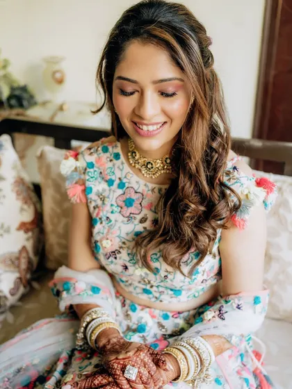 This playful Mehendi look features soft pink eyeshadow and glowing skin, perfectly matching the fun and festive vibe of her Payal Singhal lehenga.