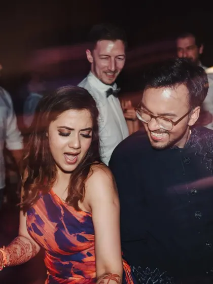 The energy of a Goa beach Sangeet. Friends and family dancing together, capturing the fun, carefree vibe of a destination wedding party.