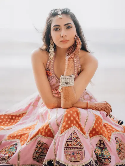 A relaxed and confident bridal portrait on the beach. This shot captures her modern style and the carefree vibe of a destination wedding.