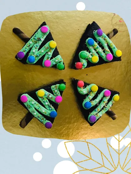 Four of my Christmas tree brownies arranged on a platter. They are a popular item for holiday orders and office parties, offering a fun, festive twist on a classic fudgy brownie.
