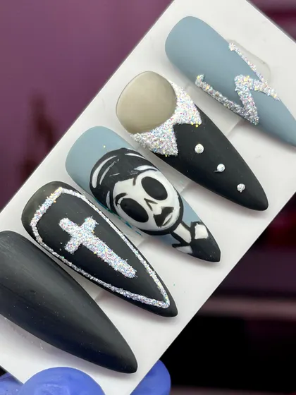 Getting into the spooky spirit with this hand-painted Halloween set, featuring a skeleton character, a coffin, and glittery accents.