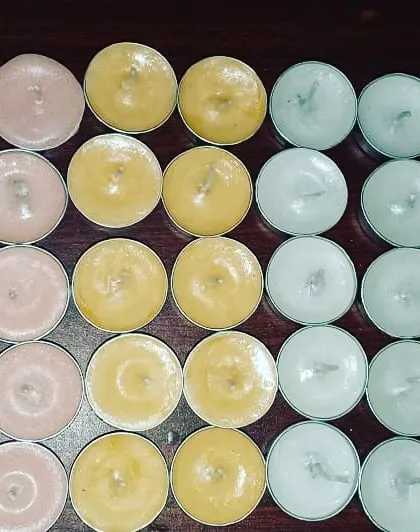 More of my colorful tealights laid out, showing the different wax options available. These are great for creating patterns or adding subtle color to your decor.