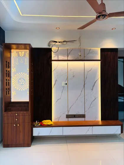 Here you can see the TV unit alongside a matching pooja unit, demonstrating how I create a unified design language across different furniture pieces in the living room.
