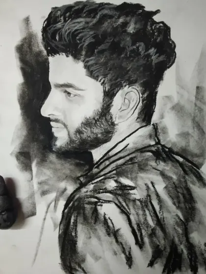 A charcoal sketch of a man in profile. The dramatic lighting and rough texture give this piece a very masculine feel.