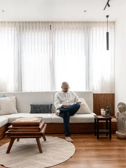 We converted what was once an outdoor balcony into this bright and cozy living area. By enclosing the space, we expanded the home's footprint and created an inviting corner that is flooded with morning light, demonstrating how smart structural changes can breathe new life into a home.