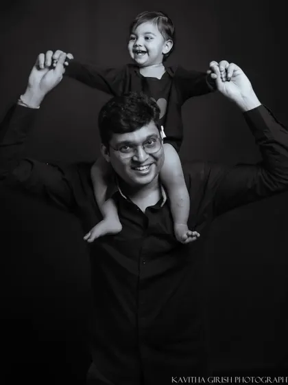 A classic black and white portrait of a father and his child. This timeless style removes all distractions, focusing purely on the strong, happy bond they share.