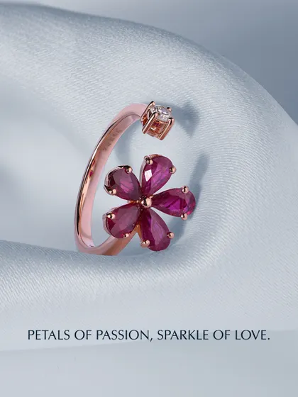 Petals of passion, sparkle of love. This open ring features a flower crafted from pear-shaped rubies, with a single diamond opposite it. The rose gold setting adds to its warmth and romance.
