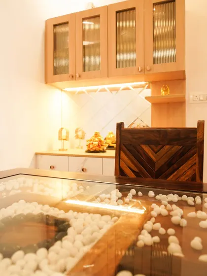 Another view of the pebble-filled dining table, showcasing its unique and artistic design.
