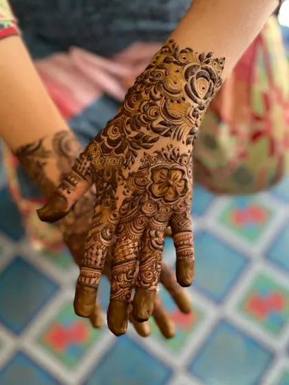 Another angle of this beautiful floral design. The large rose on the back of the hand serves as a stunning centerpiece.