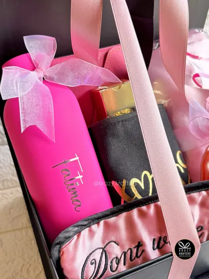 A close-up of the personalized pink bottle from our 'hug in a box' hamper for her.