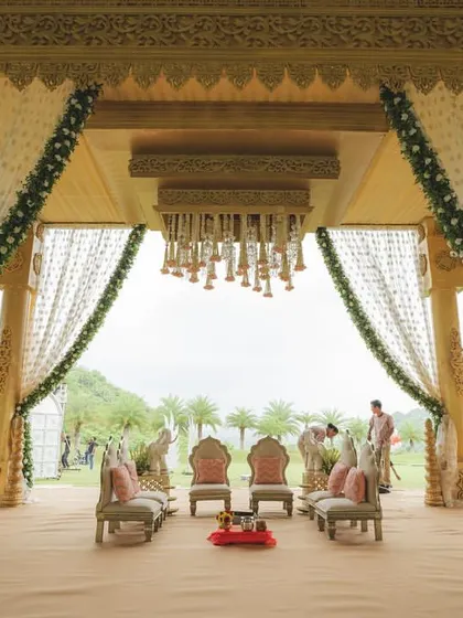 A majestic mandap set against the serene hills of Udaipur. I design wedding ceremonies that are not just visually stunning but also deeply personal and grand in scale.