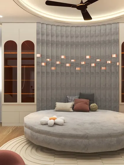 A 3D visualization of a child's bedroom with a large, round grey bed and a unique padded wall feature with small integrated lights, creating a cozy and imaginative atmosphere.