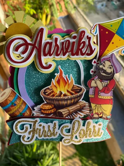A closer look at the details of our personalized First Lohri cake topper. The layered design adds depth, making the bonfire and other festive elements pop.
