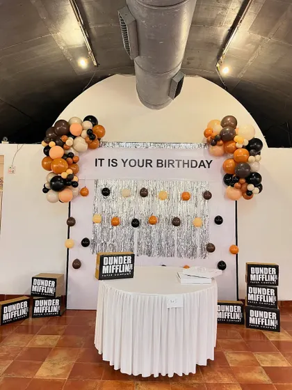 The 'Dunder Mifflin' party entrance featured a welcome sign from the "party planning committee" and stacks of branded paper boxes, setting the tone for 'The Office' theme.