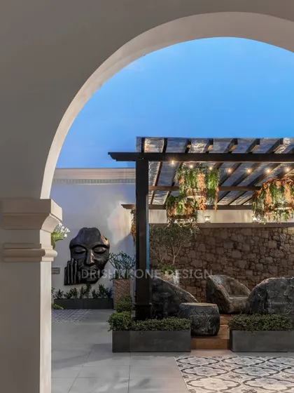 The rooftop terrace at dusk, with the pergola lights and wall art creating a magical ambiance. This space is perfect for evening gatherings or simply unwinding under the stars.
