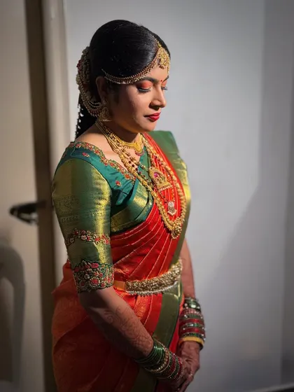A side profile showcasing Prerna's complete Muhurtham look, including her elegant hairstyle and jewelry.
