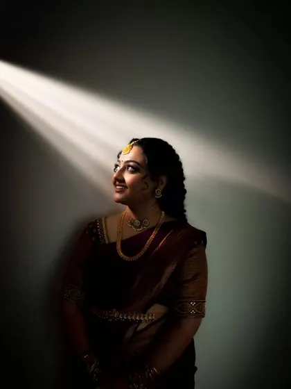 A similar portrait to the one above, capturing the bride looking up towards the light source with a gentle smile. This shot emphasizes a feeling of hope and happiness.