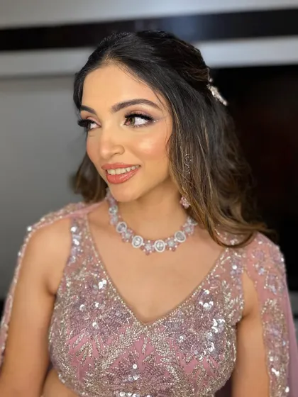 The perfect peachy-nude lip complements the soft pink tones of the eye makeup and outfit.