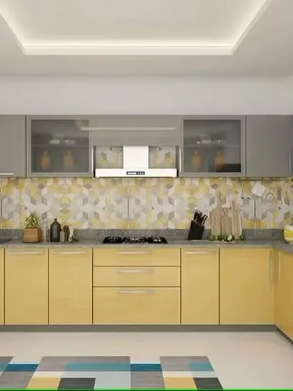 A bright and cheerful L-shaped kitchen with yellow and grey cabinets. The design is modern and practical, with a patterned backsplash that adds a playful touch.