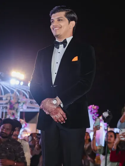 The groom's happy and proud expression as he watches his bride make her grand entrance at their fairytale reception.